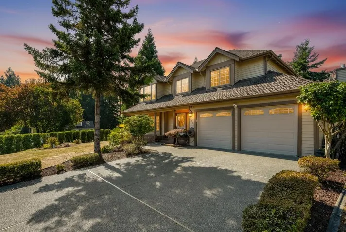 Two-story home with a three-car garage at dusk