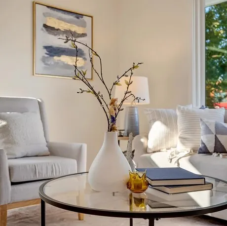 Staged living room with round glass coffee table