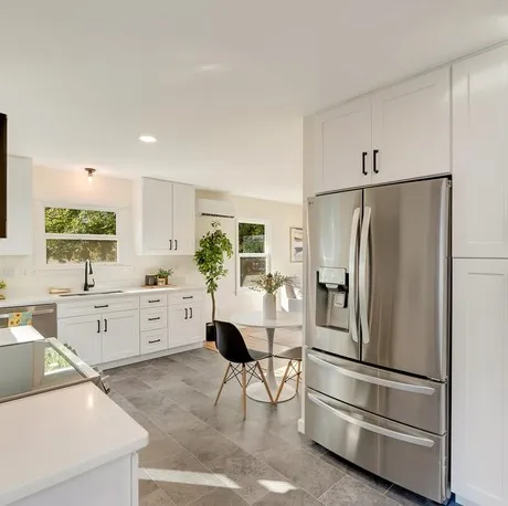 White kitchen with stainless refrigerator