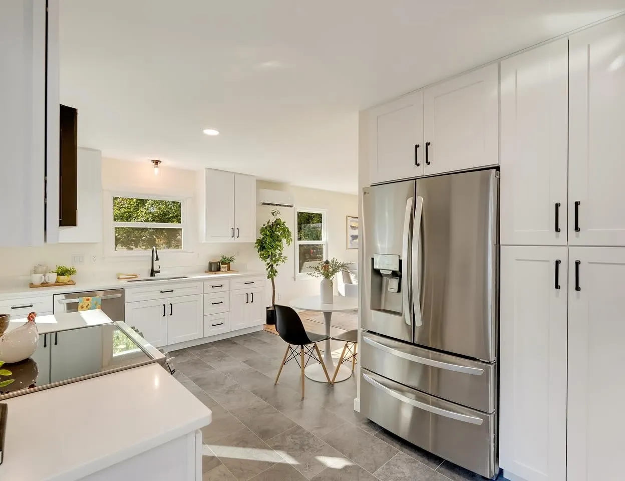 Bright white kitchen with stainless appliances and a dining nook