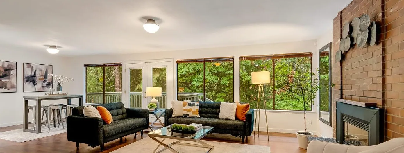 Staged living room with fireplace and garden views